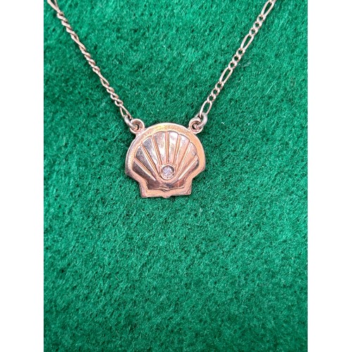 92 - A 9ct gold shell shape & diamond pendant on a 9ct gold chain - 4.5 grams