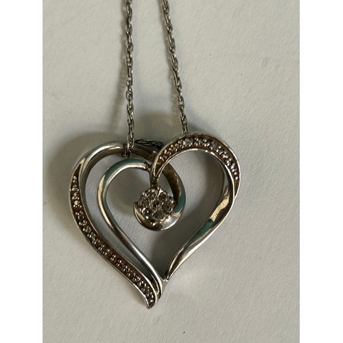 80 - Sterling silver heart shaped pendant set with a central diamond flower cluster, on a 925 silver chai... 
