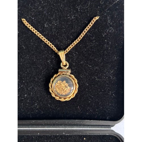 79 - A Vintage 12ct gold double sided locket containing 24ct pure gold from Sofala NSW Australia, on a gi... 