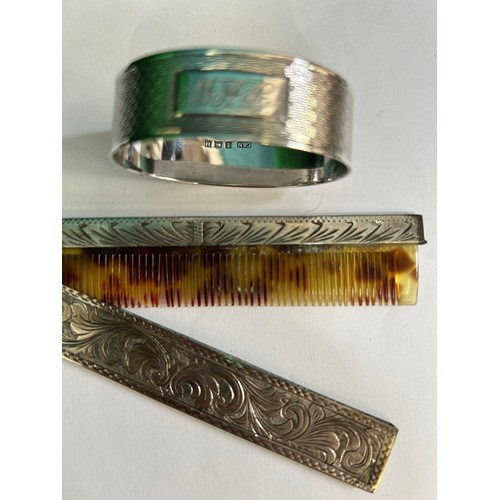 17 - Three silver pieces A silver napkin ring Birm 1957, a silver 800 French cased comb and a pencil with... 