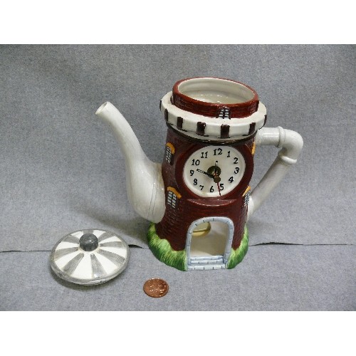 68 - CERAMIC TEAPOT CLOCK IN THE FORM OF A WINDMILL OR TOWER, BATTERY OPERATED.