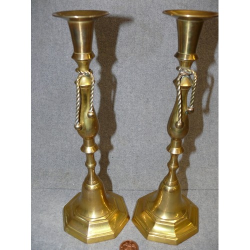 101 - PAIR OF ELEGANT BRASS CANDLESTICKS WITH TASSEL DETAIL.