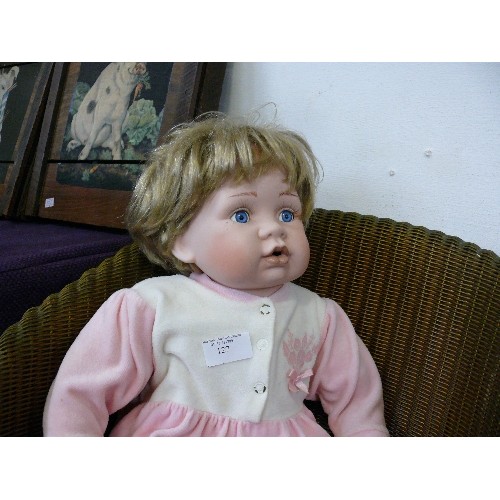 127 - LARGE PORCELAIN BABY DOLL IN PINK BABYGRO FROM LEONARDO COLLECTION.