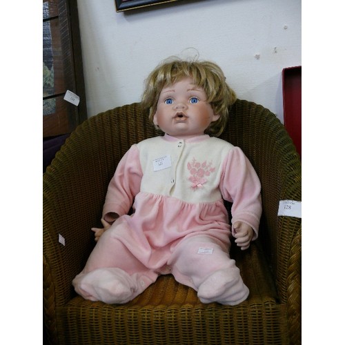 127 - LARGE PORCELAIN BABY DOLL IN PINK BABYGRO FROM LEONARDO COLLECTION.