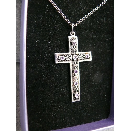 44 - A SOLID SILVER CROSS WITH CELTIC FRETWORK DESIGN PLUS 7 AMETHYSTS SET INTO IT ON A 20 INCH SILVER CH... 