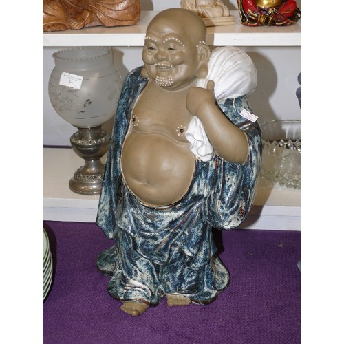 114B - LARGE CERAMIC BUDDHA IN BLUE ROBES, WITH WHITE SACK.