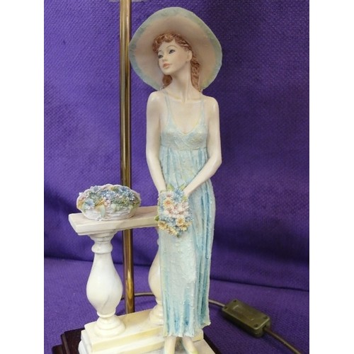 141 - ELEGANT TABLE LAMP WITH FIGURE HOLDING FLOWERS. FRINGED IVORY 'SILK' SHADE.