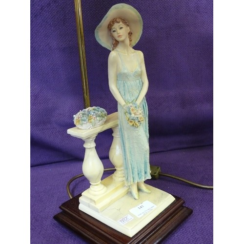 141 - ELEGANT TABLE LAMP WITH FIGURE HOLDING FLOWERS. FRINGED IVORY 'SILK' SHADE.