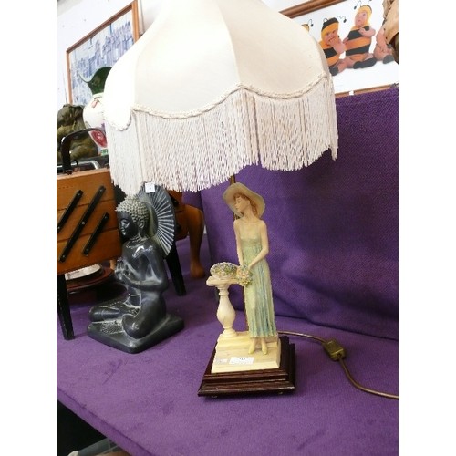 141 - ELEGANT TABLE LAMP WITH FIGURE HOLDING FLOWERS. FRINGED IVORY 'SILK' SHADE.