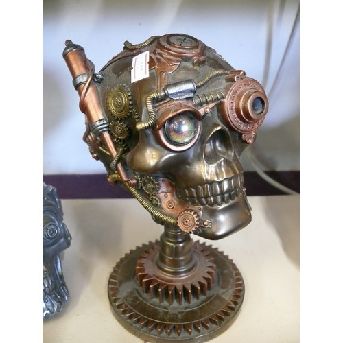 63 - 2 STEAMPUNK SKULLS, ONE WITH WORKING LIGHT