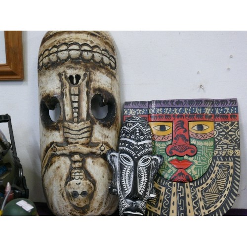 108 - A LARGE AFRICAN CARVED MASK PLUS A FURTHER MASK AND A HAND PAINTED TRIBAL PLAQUE