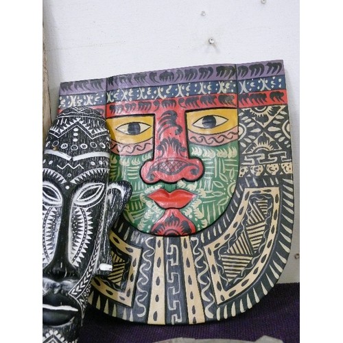 108 - A LARGE AFRICAN CARVED MASK PLUS A FURTHER MASK AND A HAND PAINTED TRIBAL PLAQUE