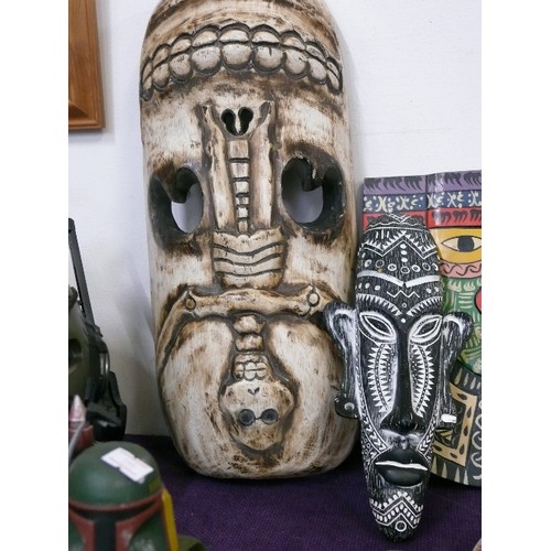 108 - A LARGE AFRICAN CARVED MASK PLUS A FURTHER MASK AND A HAND PAINTED TRIBAL PLAQUE