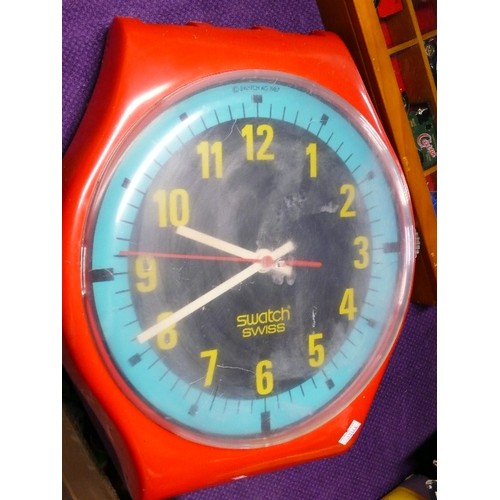 150 - A RETRO SWATCH WALL CLOCK IN THE SHAPE OF A WRISTWATCH