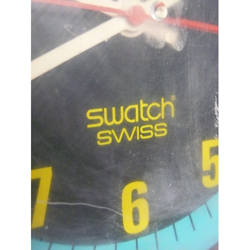 150 - A RETRO SWATCH WALL CLOCK IN THE SHAPE OF A WRISTWATCH