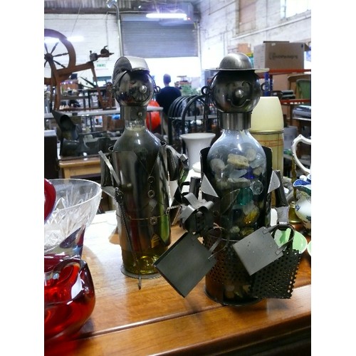 158 - A PAIR OF NOVELTY WINE BOTTLE HOLDERS, A GOLFER AND A LADY SHOPPER