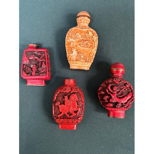 265 - A collection of Chinese snuff bottles, three in Cinnabar type lacquer and one in carved resin.