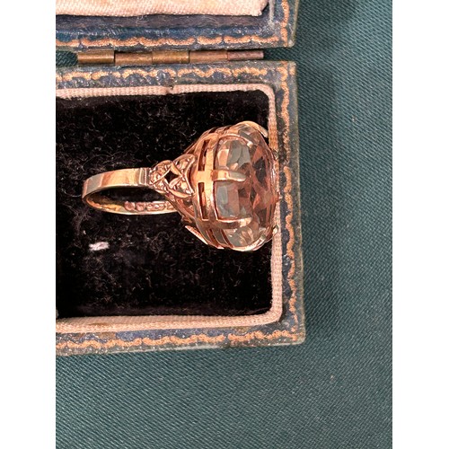 76 - A 9ct gold ring with a large certified quartz stone, ornate decoration to side of shanks, double cro... 