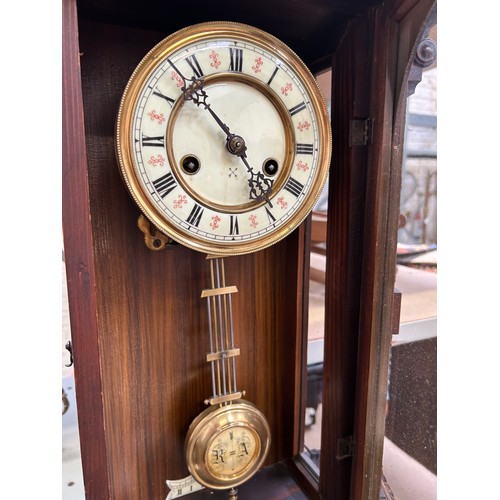 347 - An Edwardian Vienna Style wall clock by the Hamburg American Clock Company - with pendulum & key. Wo... 