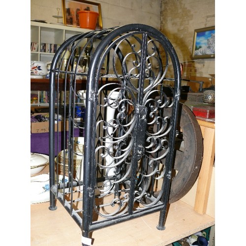 173 - AN ORNATE BLACK CAST METAL WINE HOLDER CAGE