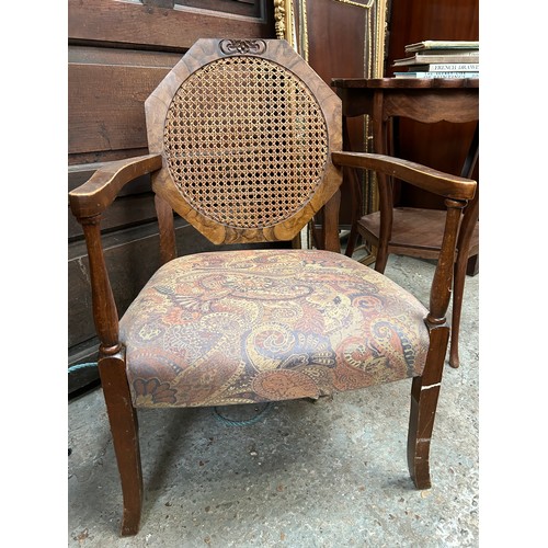 452 - An Art Deco low elbow chair with canework and walnut graining to the octagonal back