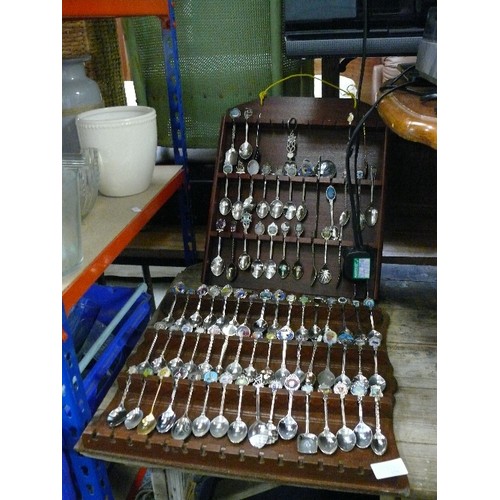 525 - TWO RACKS OF COLLECTORS SPOONS