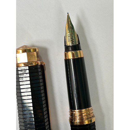 75 - A  Montegrappa Italian designer fountain pen, with 18ct gold nib, the black ribbed body and cap are ... 