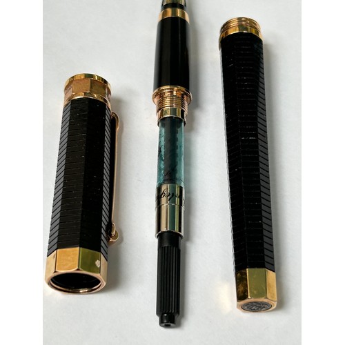 75 - A  Montegrappa Italian designer fountain pen, with 18ct gold nib, the black ribbed body and cap are ... 