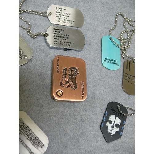 34 - Collection of 8 dog tags, possibly from games.  One is a memory stick, one other looks like a key (p... 