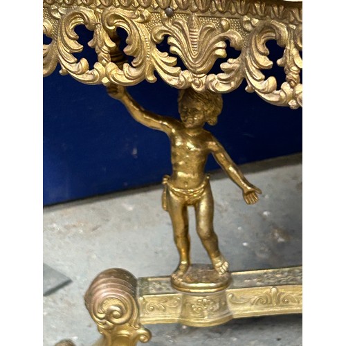 453 - Brass coffee table with ornate cherub supports on tripod base, with an onyx top, second half 20th Ce... 