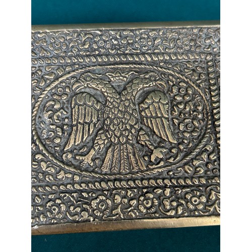 284A - A heavy vintage brass cigarette box with chrome interior, the lid with repousse work of eagles with ... 