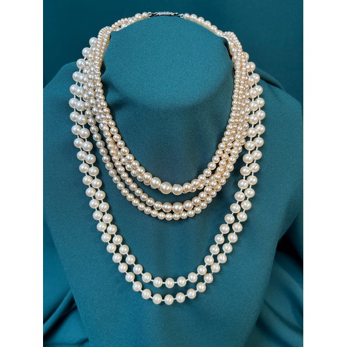 73A - Four vintage simulated pearl necklaces, three with diamanté set clasps.