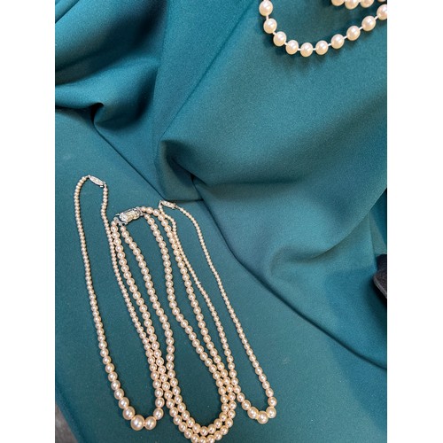 73A - Four vintage simulated pearl necklaces, three with diamanté set clasps.