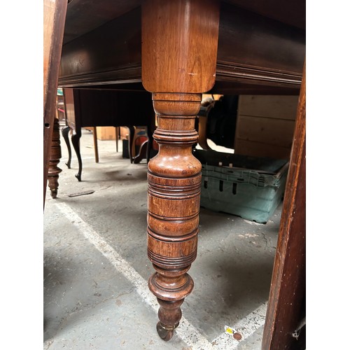 425 - Victorian mahogany wind out dining table on turned legs and original brown pot castors - with a leaf... 