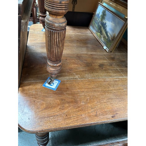 425 - Victorian mahogany wind out dining table on turned legs and original brown pot castors - with a leaf... 