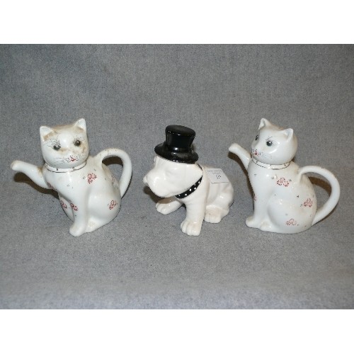 319 - A COLLECTION OF DECORATIVE CAT TEAPOTS  AND DOGS