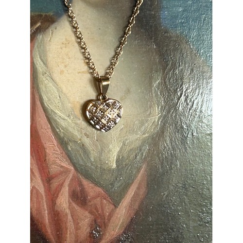 91B - A 9ct gold & diamond heart pendant on a 9ct gold chain. 2.7 grams - 54cm chain