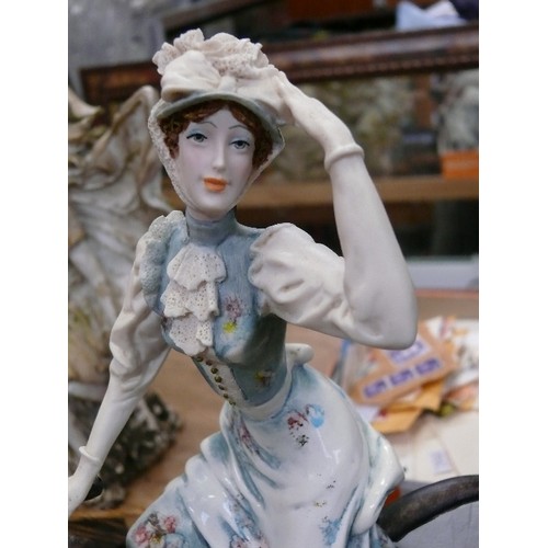 92 - A CERAMIC LADY FIGURINE ON BICYCLE
