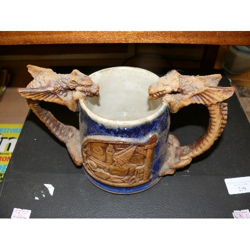 261 - A VINTAGE STONEWARE DOUBLE HANDED DRAGON MUG FEATURING WIZARDS