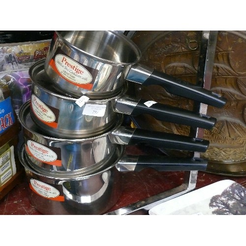 293 - A SET OF 4 STAINLESS STEEL, COPPER BASED PRESTIGE SAUCEPANS AND A NEW SPICE RACK