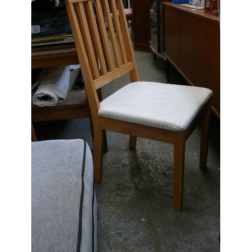 557 - PAIR OF PALE BEECH WOOD DINING CHAIRS WITH PADDED OATMEAL COLOURED SEATS