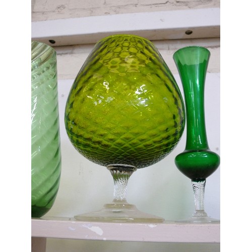 87 - 5 LARGE GREEN GLASS VASES IN VARIOUS STYLES AND SIZES