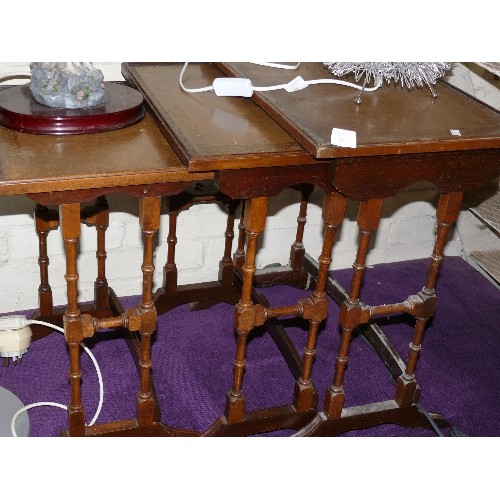 187 - A NEST OF 3 VINTAGE LEATHER TOPPED TABLES