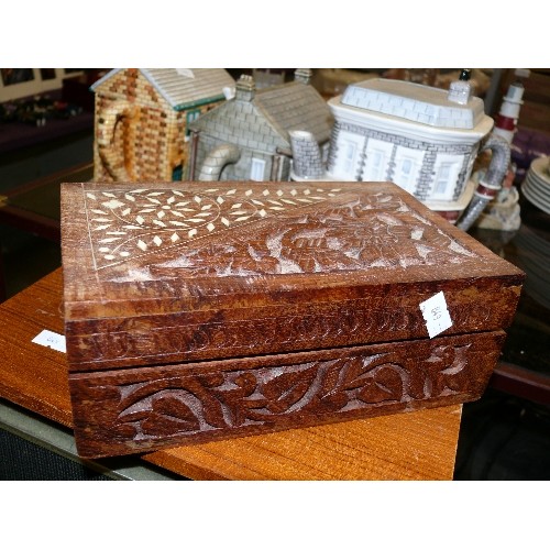 312 - A CARVED WOODEN BOX WITH CONTENTS OF SEWING ITEMS