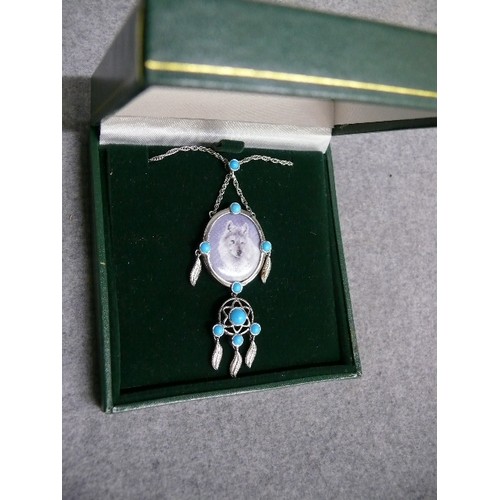 28 - A HEAVY SOLID SILVER PENDANT OF A WOLF WITH TURQUOISE DROPLETS BY ETHNIC AMERICAN INDIANS WITH SILVE... 