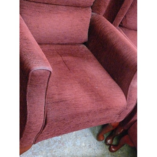 486 - HIS AND HERS FIRESIDE CHAIRS IN BURGUNDY, ONE WITH A FOOTSTOOL