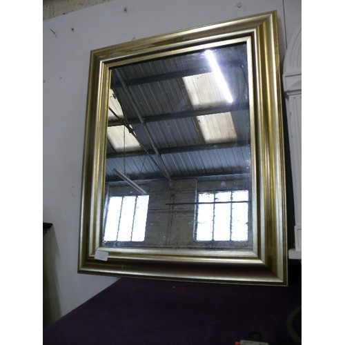 136 - A LARGE FRAMED WALL MIRROR