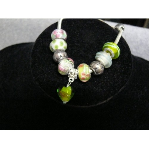 66 - A LOVELY PINK AND GREEN CHARM BRACELET WITH GLASS BEADS MARKED 925