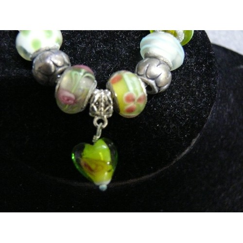 66 - A LOVELY PINK AND GREEN CHARM BRACELET WITH GLASS BEADS MARKED 925