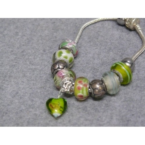 66 - A LOVELY PINK AND GREEN CHARM BRACELET WITH GLASS BEADS MARKED 925